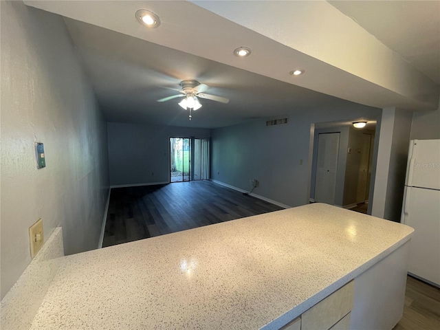 kitchen featuring dark hardwood / wood-style flooring, ceiling fan, and white refrigerator