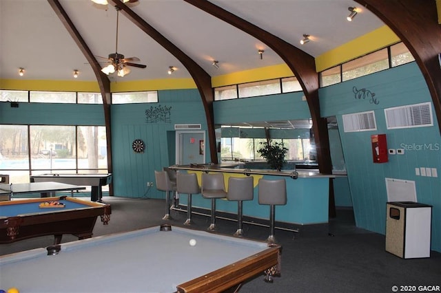 recreation room featuring a healthy amount of sunlight, billiards, high vaulted ceiling, and bar area