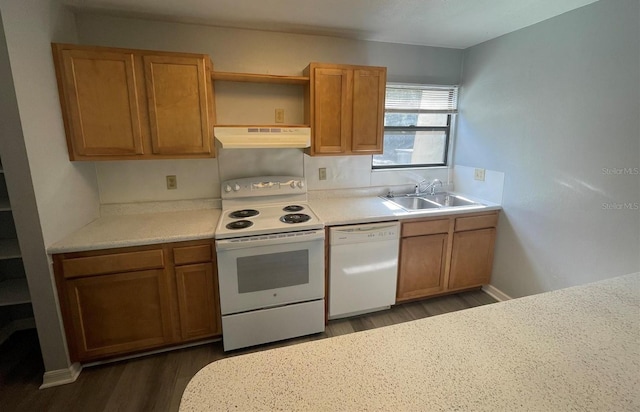 kitchen with white appliances, dark wood-type flooring, and sink