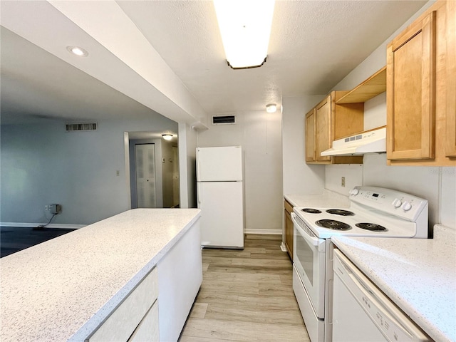 kitchen featuring light brown cabinetry, white appliances, and light hardwood / wood-style floors