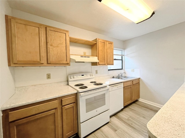 kitchen featuring white appliances, sink, and light hardwood / wood-style flooring