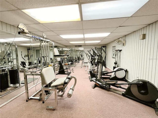 gym with a paneled ceiling