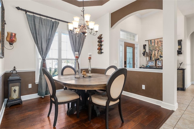 dining space featuring a notable chandelier, hardwood / wood-style floors, and crown molding