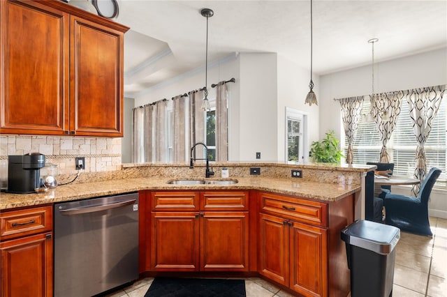 kitchen with kitchen peninsula, dishwasher, sink, and pendant lighting