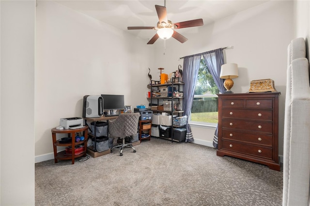 carpeted home office featuring ceiling fan