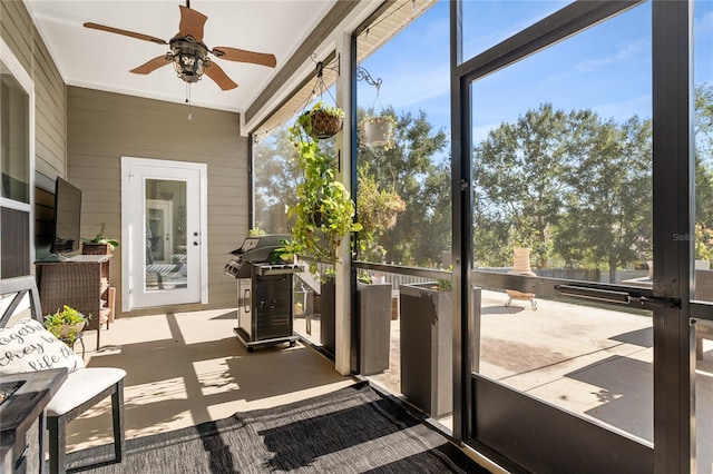 sunroom featuring ceiling fan and a wealth of natural light