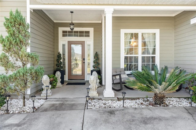 view of exterior entry with a porch