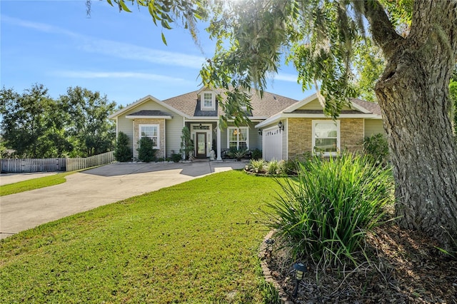 view of front of home with a front yard and a garage