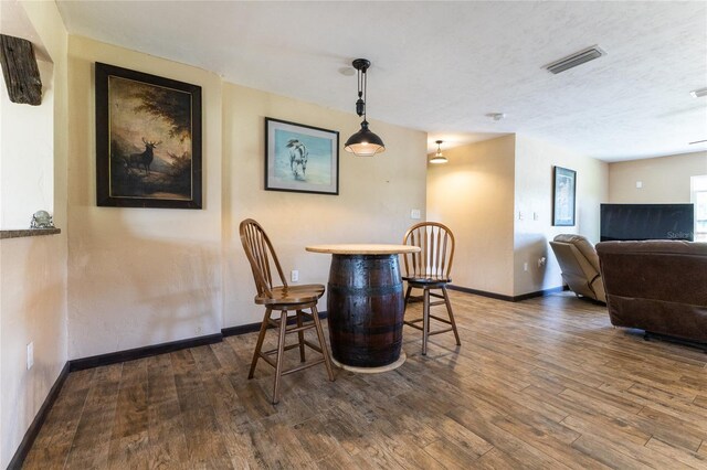 dining room with dark wood-type flooring