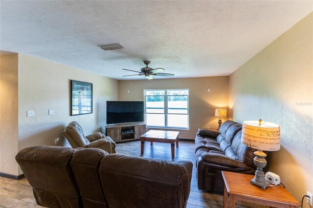 living room with wood-type flooring and ceiling fan