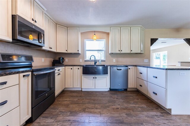 kitchen featuring sink, white cabinets, stainless steel appliances, and a healthy amount of sunlight