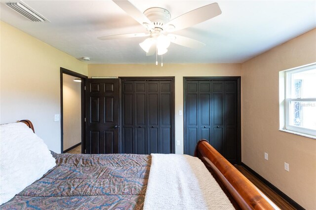 bedroom with multiple closets and ceiling fan