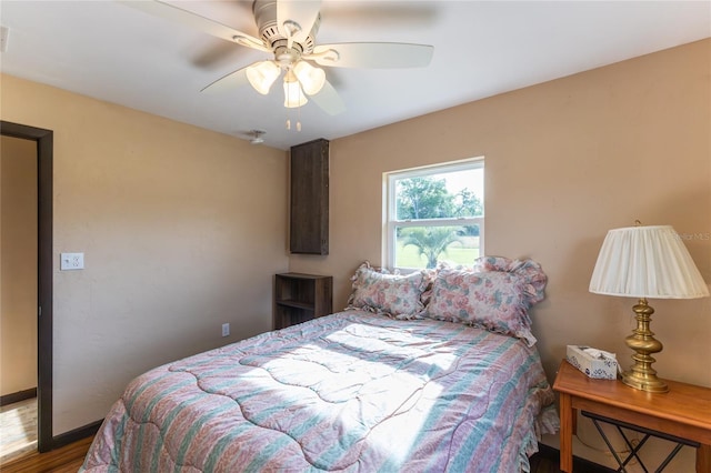 bedroom with hardwood / wood-style floors and ceiling fan