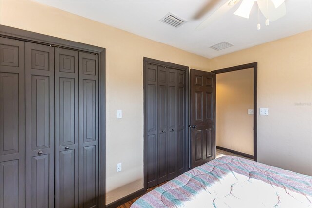 bedroom featuring multiple closets and ceiling fan