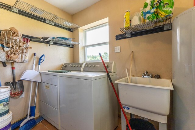 laundry area featuring sink, tile patterned floors, and washer and clothes dryer