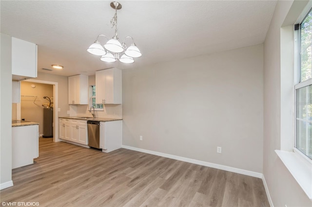 kitchen featuring dishwasher, sink, decorative light fixtures, white cabinets, and light hardwood / wood-style floors