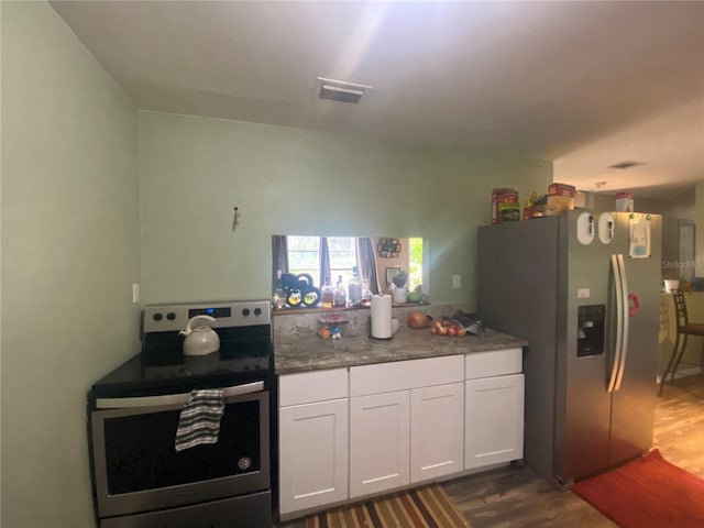 kitchen featuring white cabinets, dark hardwood / wood-style floors, and stainless steel appliances