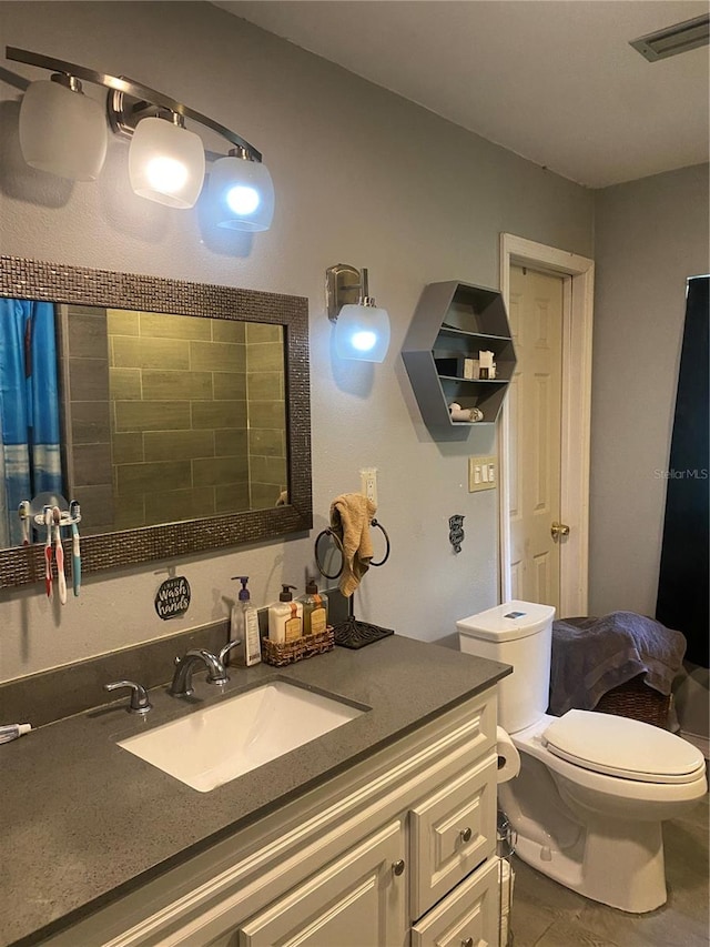 bathroom with curtained shower, tile patterned flooring, vanity, and toilet