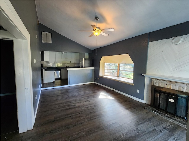 unfurnished living room with a stone fireplace, high vaulted ceiling, dark wood-type flooring, and ceiling fan