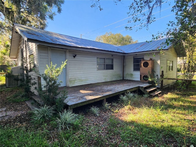 back of property with a deck and central air condition unit