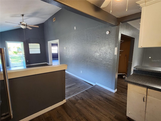 kitchen featuring ceiling fan, vaulted ceiling with beams, and dark hardwood / wood-style floors