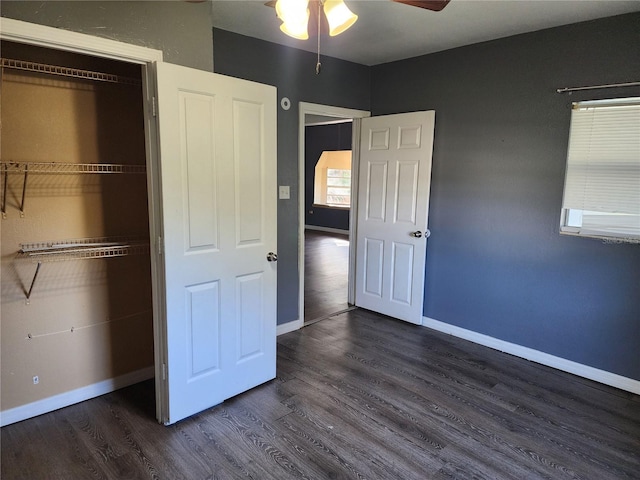 unfurnished bedroom featuring ceiling fan and dark hardwood / wood-style flooring