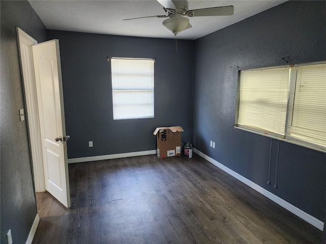 spare room featuring dark hardwood / wood-style floors and ceiling fan