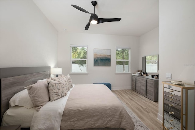 bedroom featuring light hardwood / wood-style flooring, multiple windows, and ceiling fan