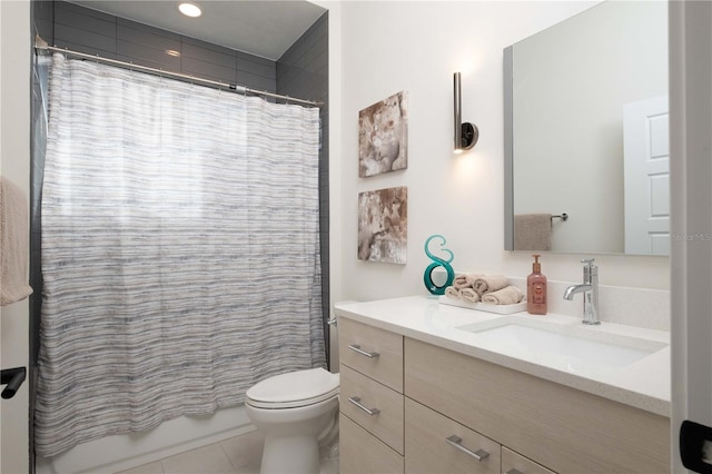 bathroom featuring tile patterned flooring, vanity, and toilet