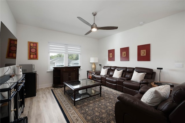 living room with ceiling fan and light wood-type flooring