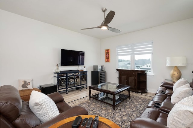 living room with light hardwood / wood-style floors and ceiling fan