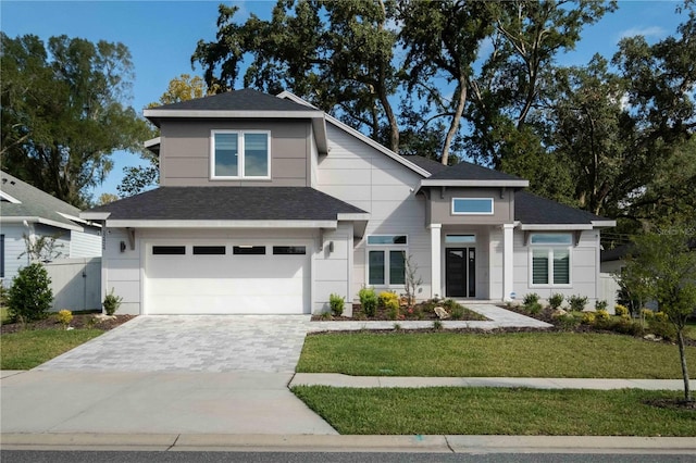 view of front facade featuring a front yard and a garage