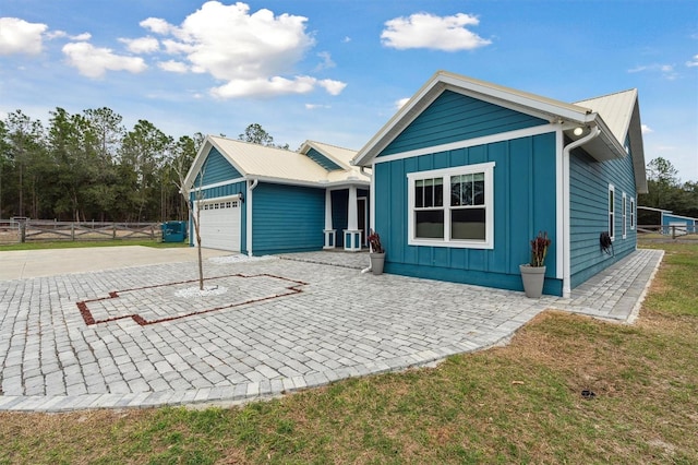 view of front of house with a front yard and a garage