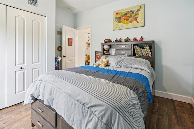 bedroom featuring a closet and dark hardwood / wood-style flooring