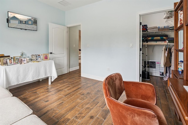 bedroom with a closet and dark hardwood / wood-style floors