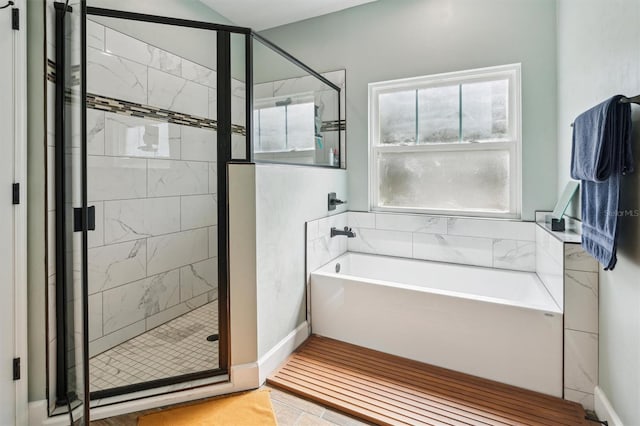 bathroom featuring shower with separate bathtub