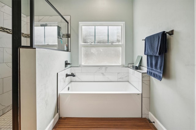 bathroom with a wealth of natural light and independent shower and bath