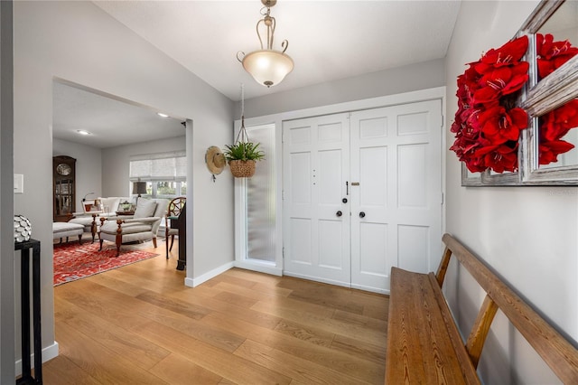 entrance foyer with hardwood / wood-style floors and lofted ceiling