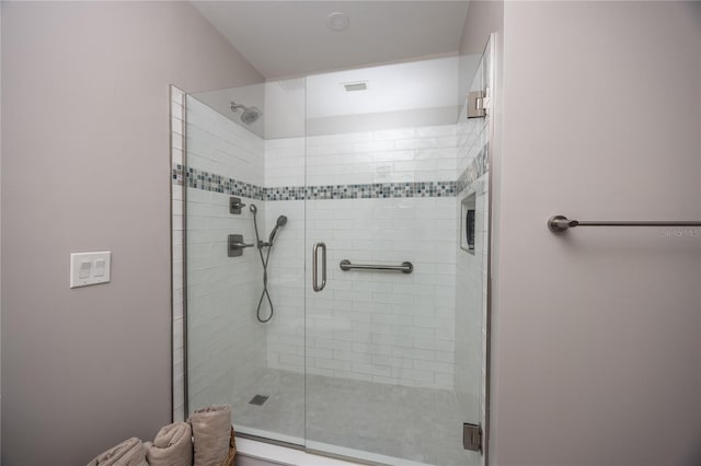 bathroom with a shower with shower door