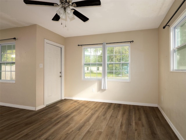 unfurnished room with dark wood-type flooring, ceiling fan, and plenty of natural light