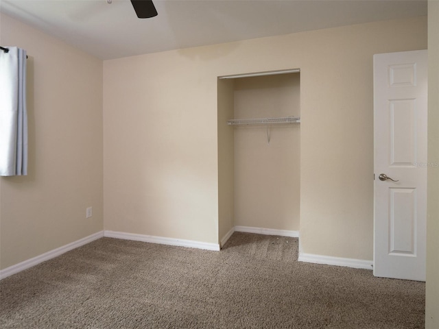 unfurnished bedroom featuring a closet, ceiling fan, and carpet flooring