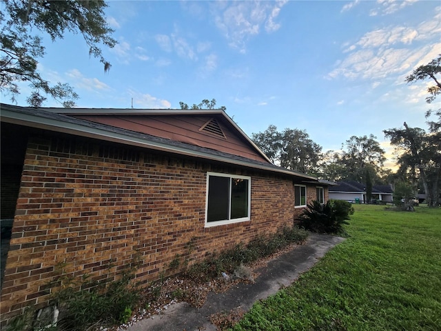 property exterior at dusk with a yard