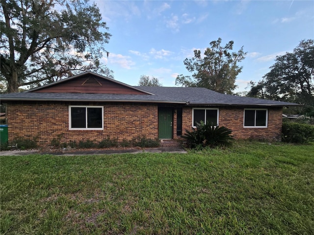 ranch-style house with a front lawn