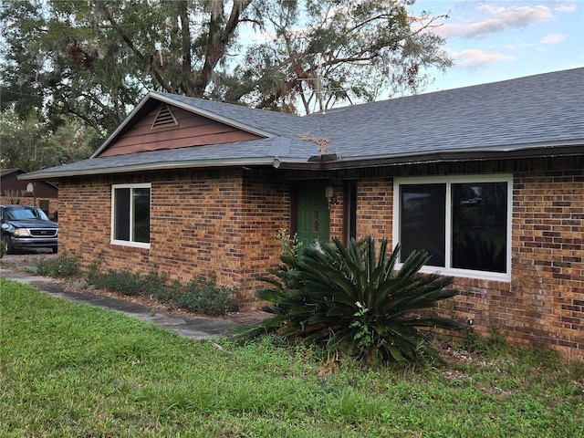 view of property exterior featuring a lawn