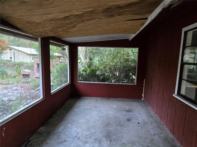 unfurnished sunroom featuring vaulted ceiling and wood ceiling