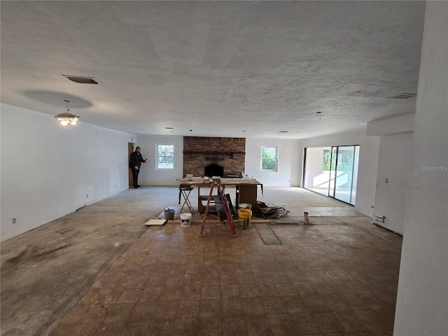 unfurnished living room featuring a wealth of natural light