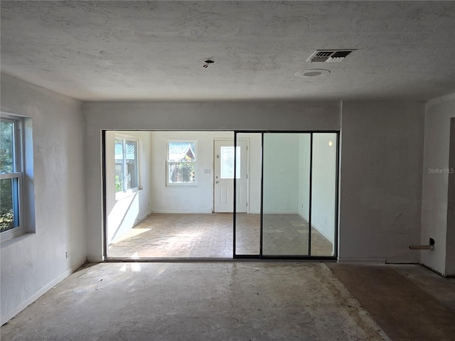 interior space with a textured ceiling