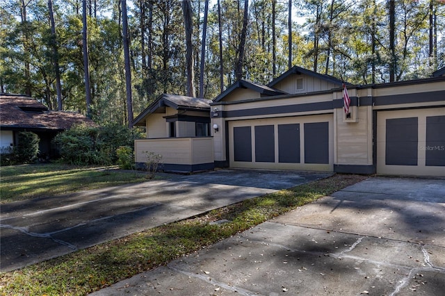 view of front of home with a garage, board and batten siding, and driveway