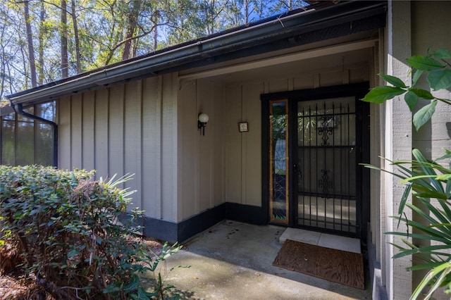 view of exterior entry with board and batten siding