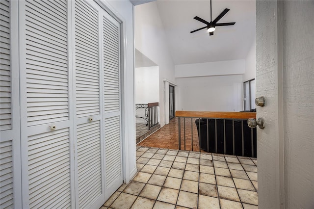 corridor with tile patterned floors and lofted ceiling